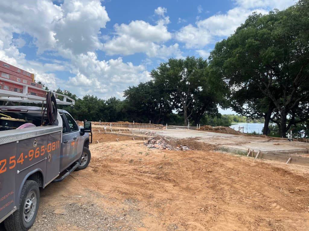 New construction foundation and underground plumbing rough-in at a lakeside jobsite in Stephenville, TX