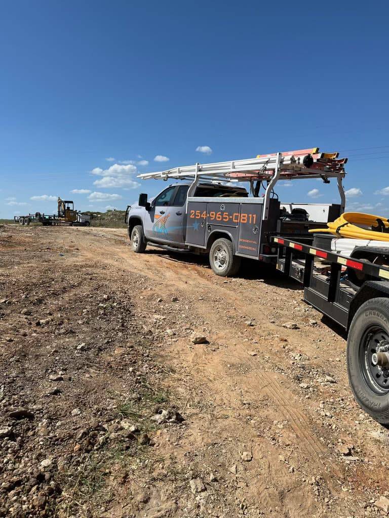 TX Plumbing Service & Repair truck staged near foundation plumbing lines during new construction